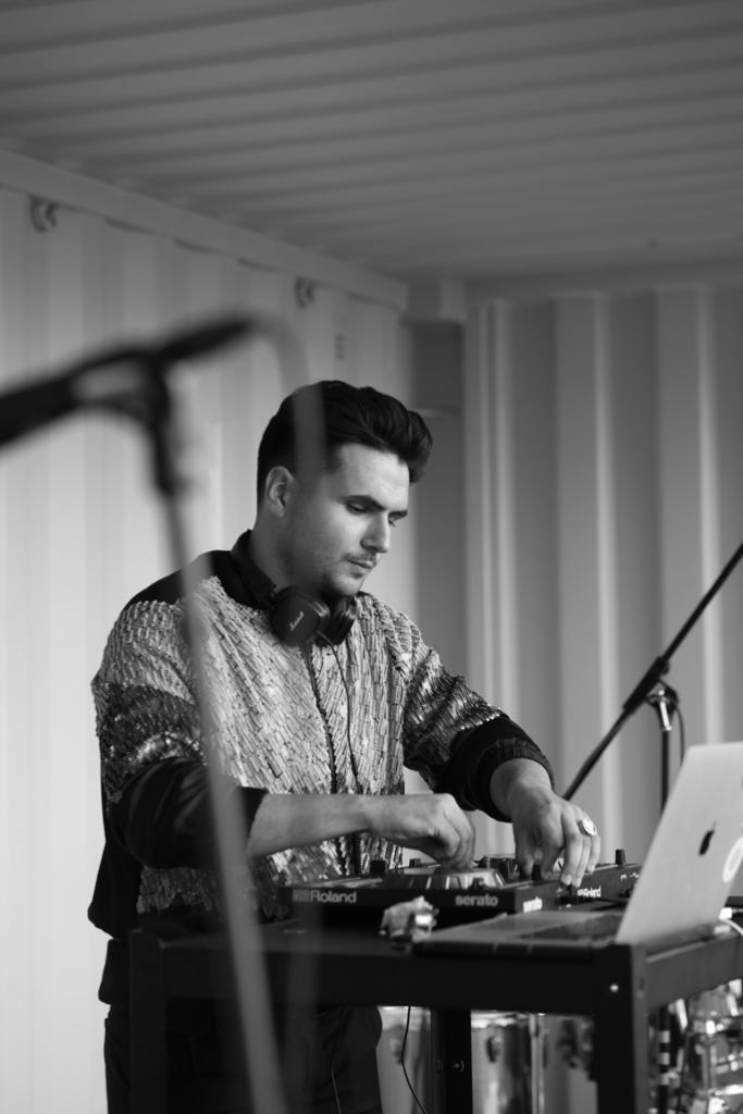Black and white shot of Trim Biba playing a Roland controller