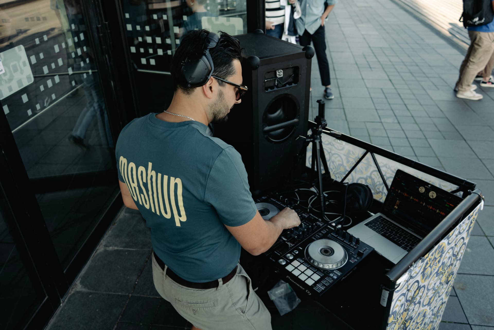 Trim Biba playing a street set from a tiled DJ cart in Malmö