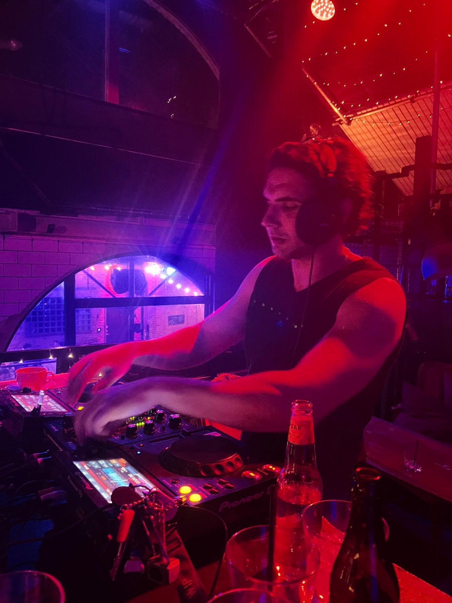 Trim Biba mixing on Pioneer decks under red club lighting