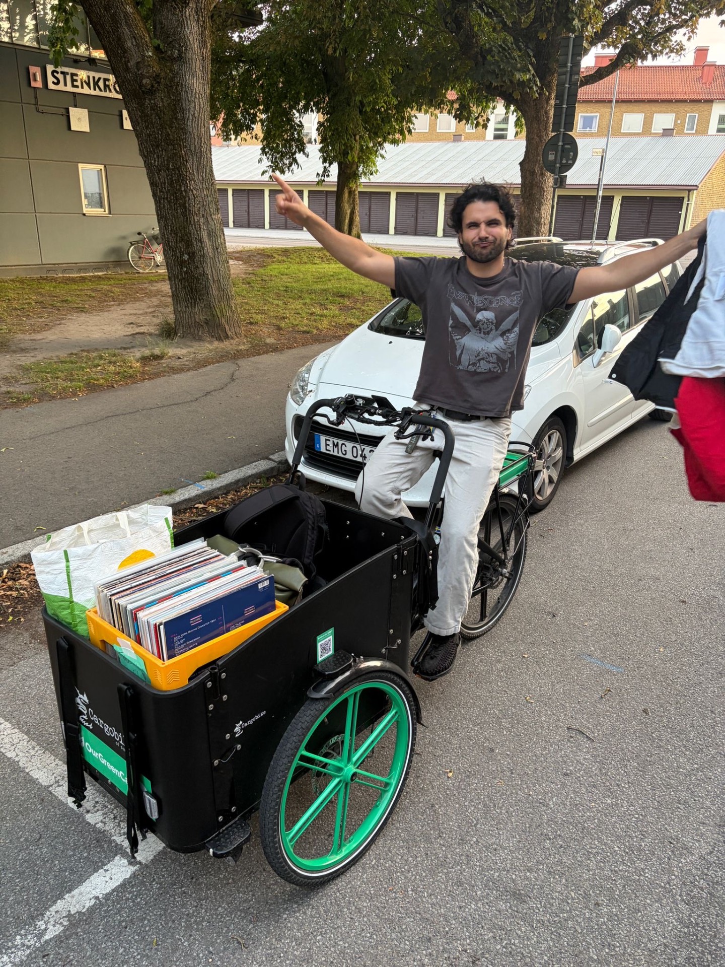 Trim Biba on a cargo bike loaded with crates of vinyl